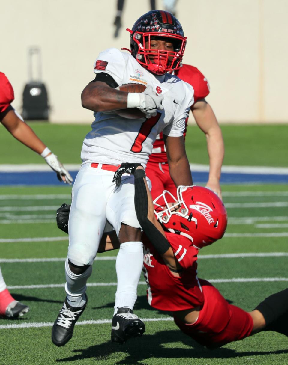 Rodney Fields escapes the tackle of Andrew Hancock at a semi-final playoff game as Del City plays Claremore on Nov 24, 2023; in Noble, Oklahoma, USA; at Noble High School. Mandatory Credit: Steve Sisney-The Oklahoman