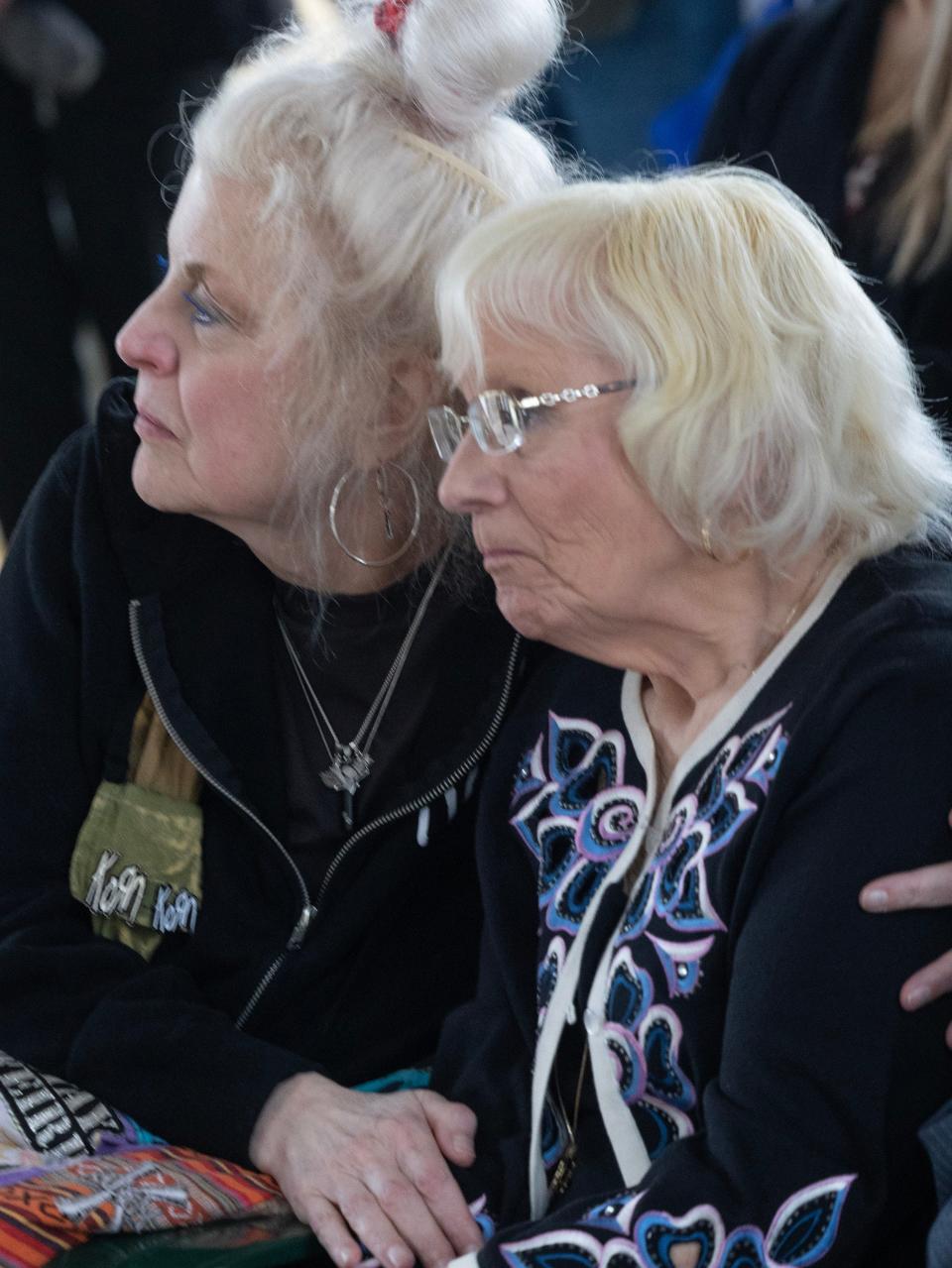 Kelly Rhodes, left, the daughter of Lynn Such, a cousin of U.S. Navy Fireman 1st Class Walter Schleiter, comforts her mother during his military funeral service.
