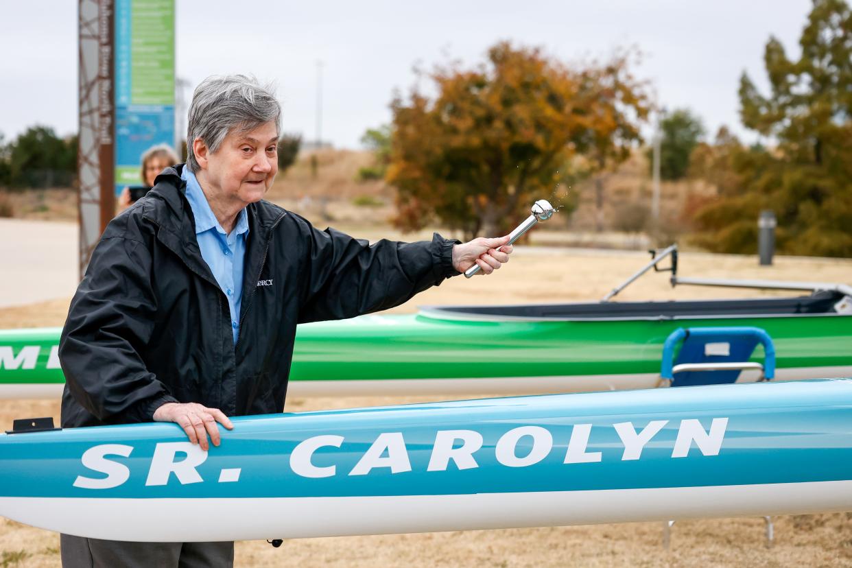 Sister Carolyn Stoutz christens a boat named after her on Saturday during a ceremony hosted by Riversport OKC and Mercy honoring the Sisters of Mercy at Chesapeake Boathouse in Oklahoma City.
