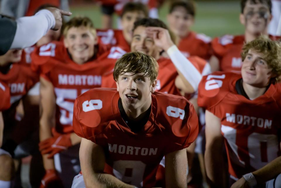 Morton running back Seandon Buffington and the rest of the Potters listen to accolades from their coach after their Week 4 football game Friday, Sept. 15, 2023 in Morton. The Potters downed the Metamora Redbirds 45-19.