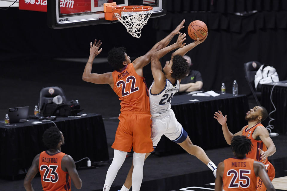 Villanova's Jeremiah Robinson-Earl, center right, goes up for a basket as Virginia Tech's Keve Aluma defends during the first half of an NCAA college basketball game, Saturday, Nov. 28, 2020, in Uncasville, Conn. (AP Photo/Jessica Hill)