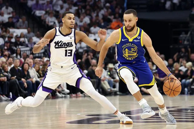 <p>Ezra Shaw/Getty Images</p> Stephen Curry and Keegan Murray during the Play-In Tournament at Golden 1 Center on April 16, 2024 in Sacramento, California