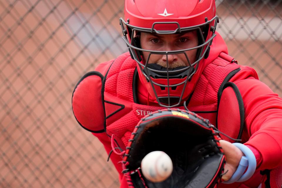 Reds catcher Tyler Stephenson  practices his receiving by working with the pitching machine during the final preseason workout at GABP Wednesday.