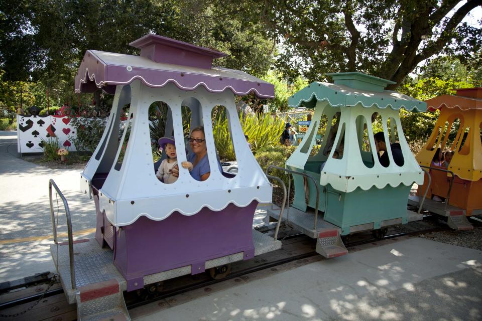 In this photo take Thursday July 12, 2012, the "Jolly Trolly" makes its way through Fairyland in Oakland, Calif. Growing up in the shadow of an icon is never a shoe-in, whether you’re a wannabe princess related to that attention-grabbing vamp Cinderella or a city living next door to fabled San Francisco. (AP Photo/Eric Risberg)