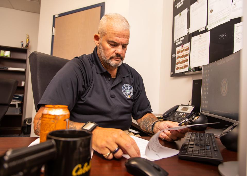 Ocala Police Sgt. Ron Malone works from his desk on April 24.