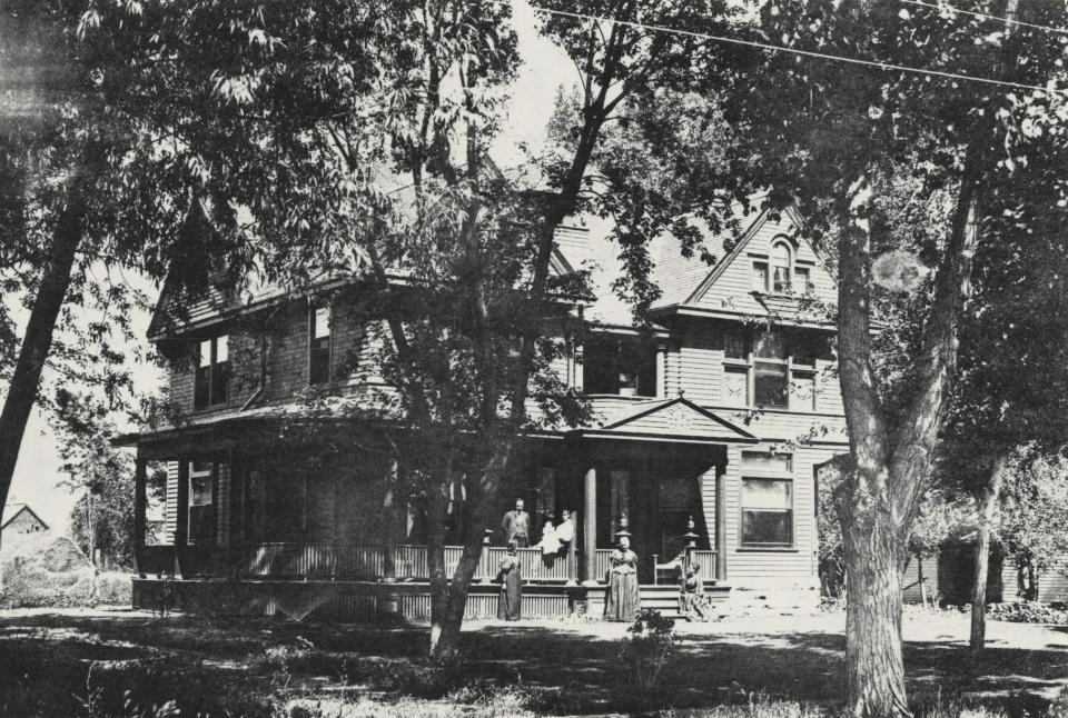 The Boutons stand outside of their home at 113 Sherwood St. around 1895. Judge Jay Bouton, pictured on the porch, had the Victorian house built for his family. His wife, Celestia, is standing at the center.