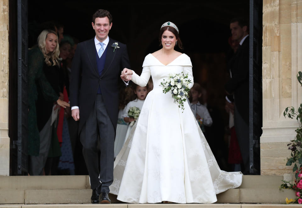 File photo dated 12/120/18 of Princess Eugenie and Jack Brooksbank on the steps of St George's Chapel in Windsor Castle after their wedding. The wedding outfits of Princess Eugenie and Jack Brooksbank on display at Windsor Castle in the exhibition A Royal Wedding: HRH Princess Eugenie and Mr Jack Brooksbank, which will run from 1 March to 22 April 2019.