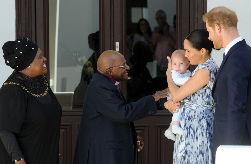 TOPSHOT - Britain's Duke and Duchess of Sussex, Prince Harry and his wife Meghan hold their baby son Archie as they meet with Archbishop Desmond Tutu and his wife Leah at the Tutu Legacy Foundation  in Cape Town on September 25, 2019. (Photo by HENK KRUGER / POOL / AFP)        (Photo credit should read HENK KRUGER/AFP/Getty Images)