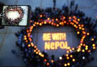 Nepalese and Chinese students gather to pray for Nepal in Nanhua University in Hengyang, central China's Hunan province