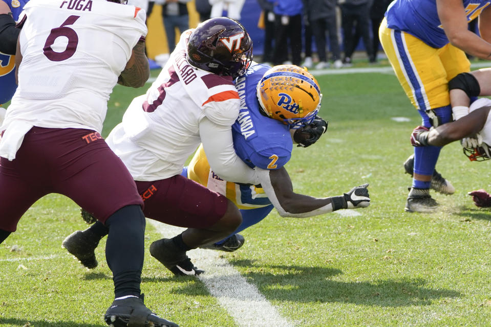 Pittsburgh running back Israel Abanikanda is tackled by Virginia Tech defensive lineman Norell Pollard as he gets out of the end zone during the first half of an NCAA college football game, Saturday, Oct. 8, 2022, in Pittsburgh. (AP Photo/Keith Srakocic)