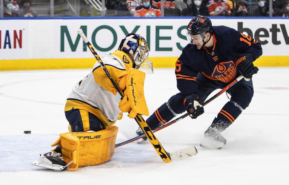 Nashville Predators' goalie Juuse Saros (74) makes the save on Edmonton Oilers' Zach Hyman (18) during the third period of an NHL hockey game, Thursday, Jan. 27, 2022 in Edmonton, Alberta. (Jason Franson/The Canadian Press via AP)