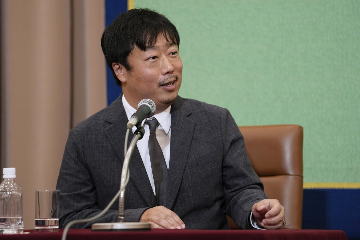 Producer Akihisa Yamamoto, with film director Ryusuke Hamaguchi and actor Hidetoshi Nishijima, unseen, speaks during a news conference on their award winning film "Drive My Car" in Tokyo, Tuesday, April 5, 2022. Japan's "Drive My Car" has won an Oscar for best international feature. (AP Photo/Hiro Komae)