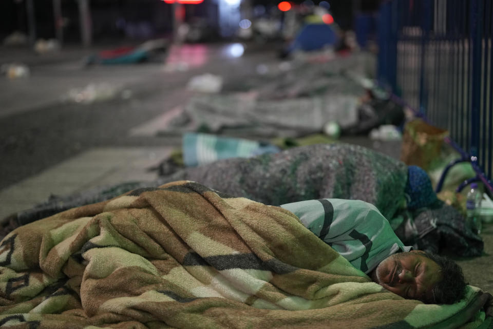 Homeless people sleep at Patio do Colegio Square during a cold night in downtown Sao Paulo, Brazil, early Friday, May 20, 2022. The homeless population in Sao Paulo has increased 30% during the COVID-19 pandemic, a recent census shows. (AP Photo/Andre Penner)