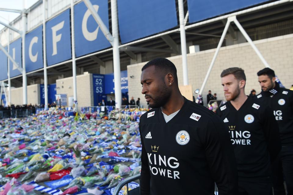 Wes Morgan (L) looks at the floral tributes (Photo by Mike Egerton/PA Images via Getty Images)