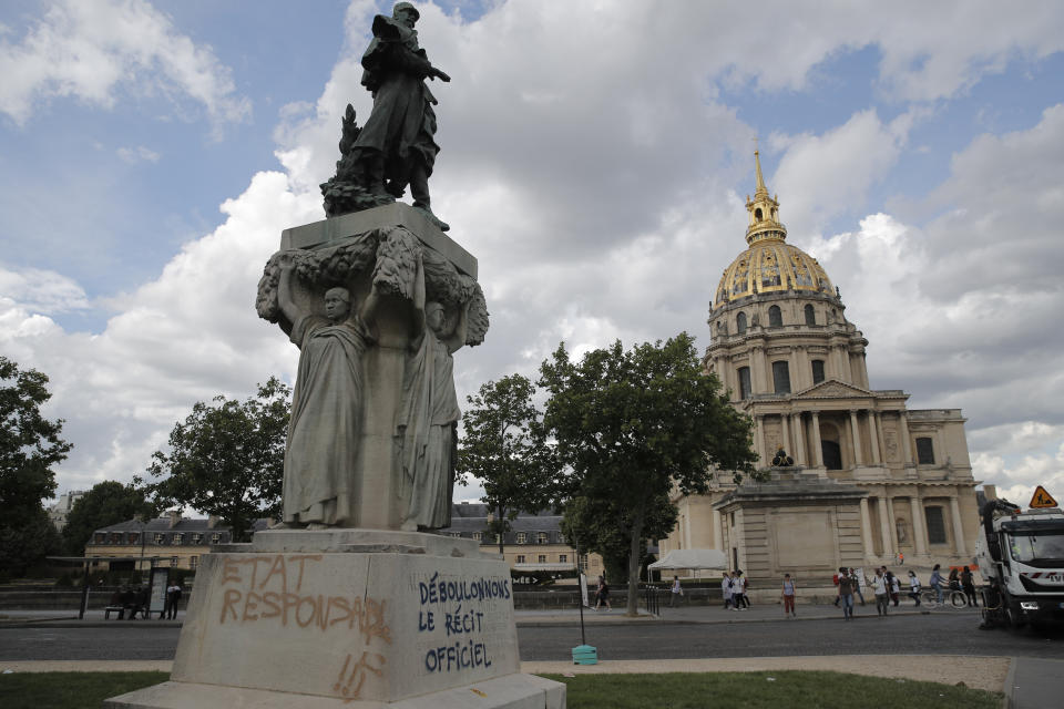 FILE - Graffitis reading "down with the official version, right, and "State responsible" are seen on the basement of the statue of French military commander Joseph Gallieni, outside the Invalides monument, right, Tuesday, June 16, 2020 in Paris. Gallieni began a colonial career at the end of the 19th century and later played an important role during First World War as a military governor of Paris. France's highest court has rejected a request by three groups seeking reparations for slavery in a case that originated on the French Caribbean island of Martinique. The court's decision on Wednesday July 5, 2023 said no individual produced evidence showing they had "suffered individually" any damage from the crimes that their ancestors had been subjected to. (AP Photo/Christophe Ena, File)