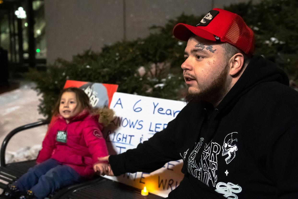 Damik Wright (R), brother of Daunte Wright, poses with his daughter outside the Hennepin County Government Center in Minneapolis, Minn. on Dec. 22, 2021, after jury deliberations in the trial of former police officer Kim Potter.