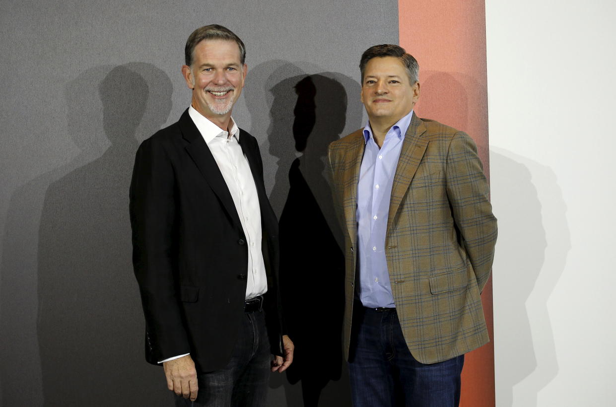 Netflix founder and Chief Executive Reed Hastings (L) and Netflix Chief Content Officer Ted Sarandos pose for photographers during an event to launch the streaming service in Italy, in Milan October 22, 2015.  REUTERS/Alessandro Garofalo