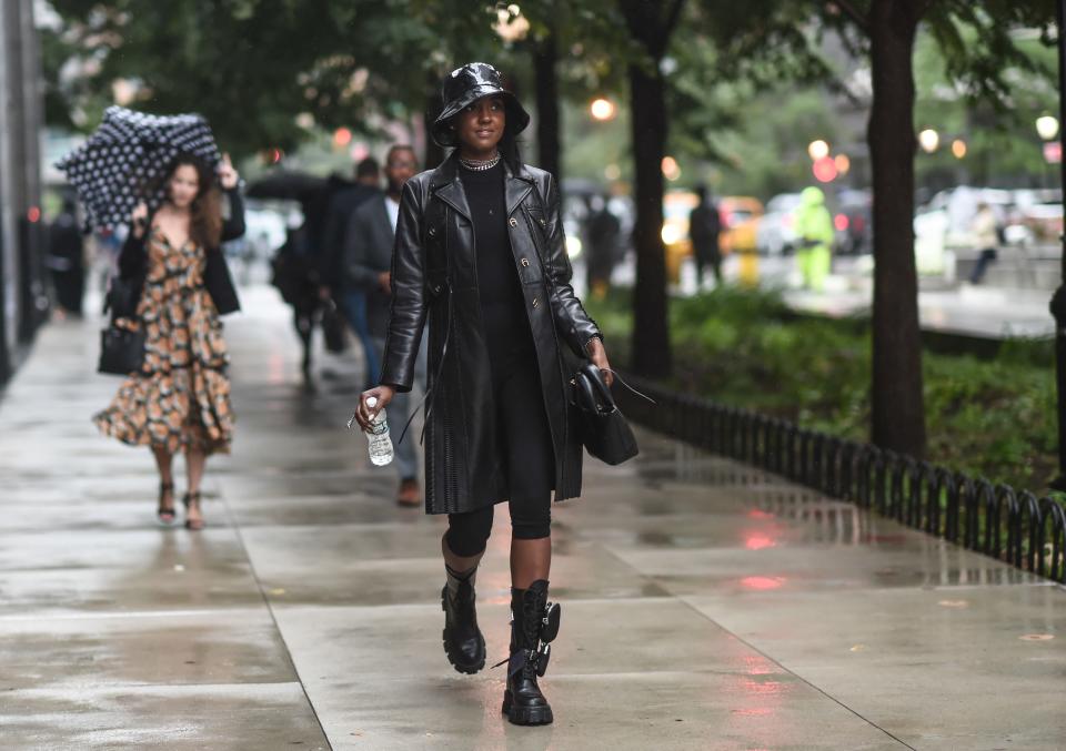 The boots, the bucket hat, and that can't-miss-me trench make this so much more than a simple all-black ensemble.