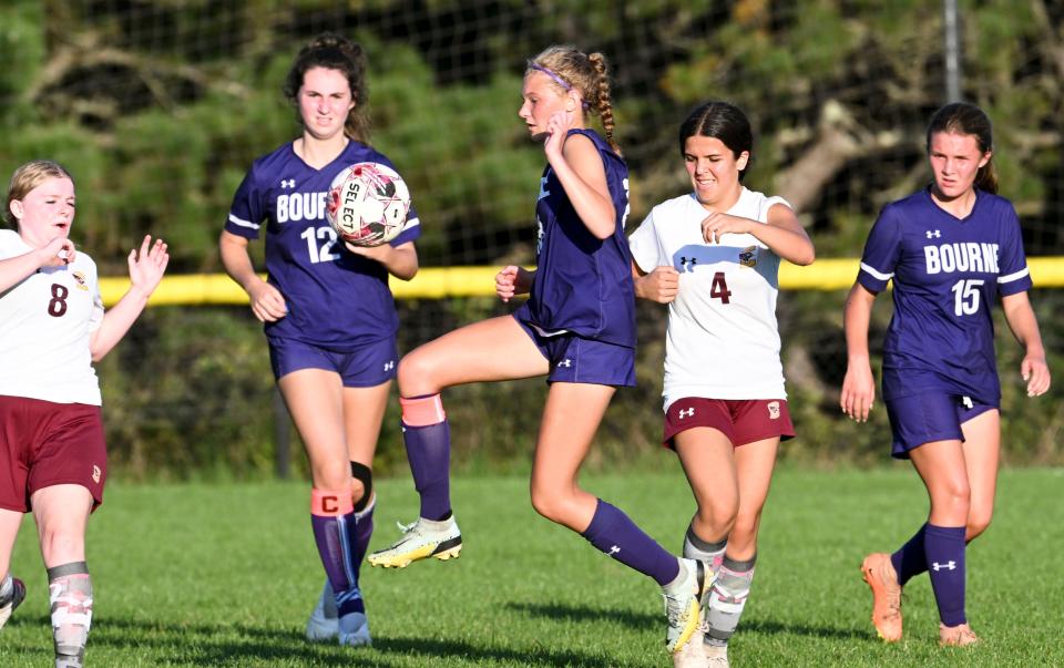 Zoe Ridl of Bourne moves the ball past McKenna Byrne (8) and Abbie Golembewski of Case.