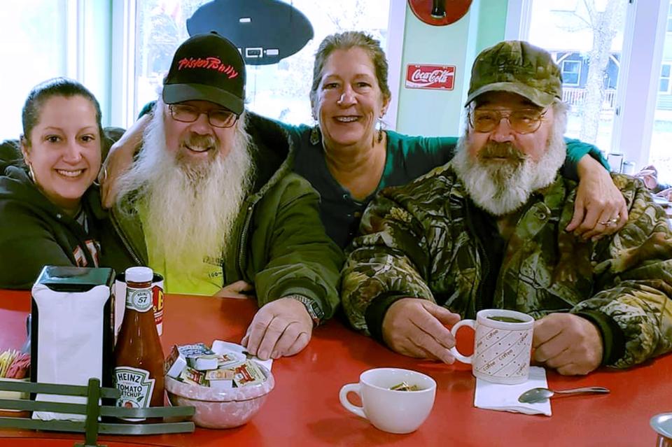 This fall 2019 photo provided by Betsey Reagan shows Leon Boyd, second from left, and his twin brother Cleon Boyd, right, with Marissa Pasani, left, and Karen Pasani, second from right, at Betsey's Dot's of Dover restaurant in Dover, Vt. Cleon died from the coronavirus on April 3, 2020. Leon also died from the coronavirus less than a week later. (Betsey Reagan via AP)