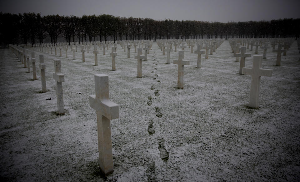 FILE - In this Tuesday, Oct. 30, 2018 file photo footsteps are seen as the snow falls at the Meuse-Argonne American WWI cemetery in Romagne-Sous-Montfaucon, France. Light snow fell across the region early on Tuesday morning. (AP Photo/Virginia Mayo)