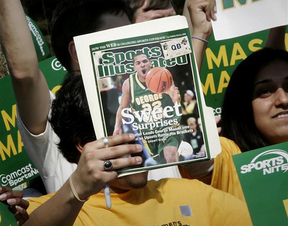 A George Mason University fan holds up the cover of Sports Illustrated magazine on March 29, 2006, in Fairfax, Va., at a send off for the men's basketball team, which was headed to Indianapolis for the NCAA Men's Basketball Final Four.