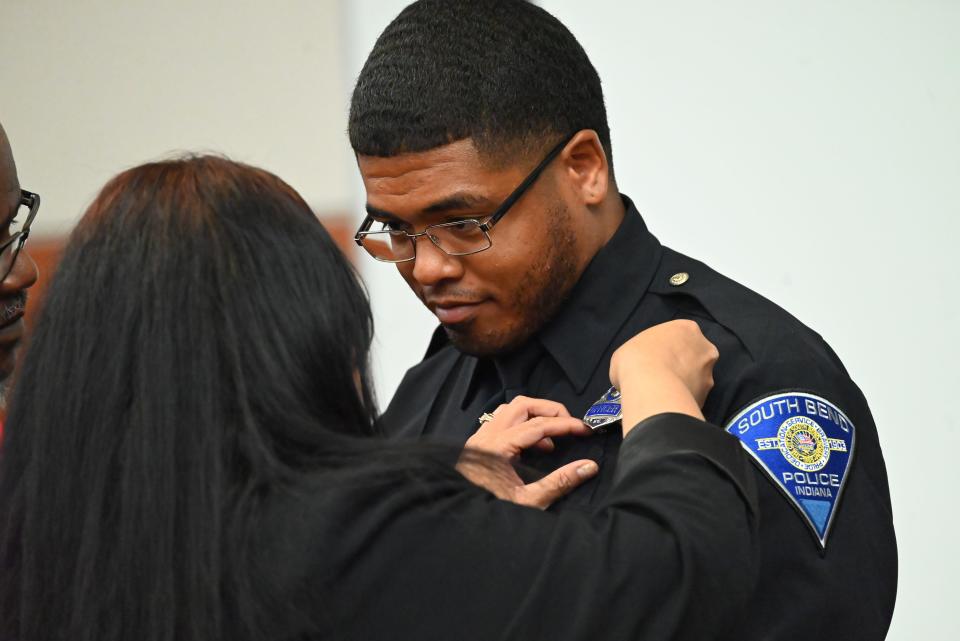 Nathaniel Taborn looks at his mother, Jenny, while being pinned into the South Bend Police Department on May 15, 2024.