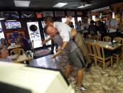 President Barack Obama, right, is picked up and lifted off the ground by Scott Van Duzer, left, owner of Big Apple Pizza and Pasta Italian Restaurant during an unannounced stop in Ft. Pierce, Fla., Sept. 9, 2012. (Pablo Martinez Monsivais / AP Photo)