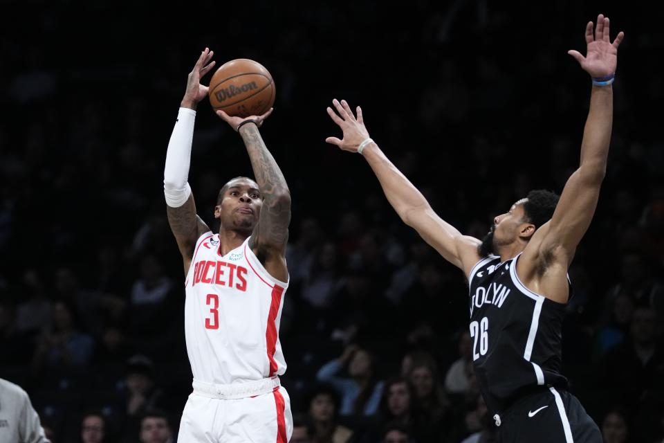 Houston Rockets' Kevin Porter Jr. (3) shoots over Brooklyn Nets' Spencer Dinwiddie (26) during the first half of an NBA basketball game, Wednesday, March 29, 2023, in New York. (AP Photo/Frank Franklin II)