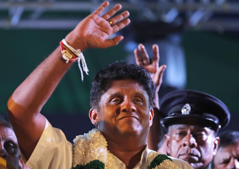 In this Monday, Nov 11, 2019 photo, Sri Lanka's ruling party presidential candidate Sajith Premedasa waves to supporters during a rally in Negombo, Sri Lanka. Sri Lankans will be voting Saturday for a new president after weeks of campaigning that largely focused on national security and religious extremism in the backdrop of the deadly Islamic State-inspired suicide bomb attacks on Easter Sunday. (AP Photo/Eranga Jayawardena)