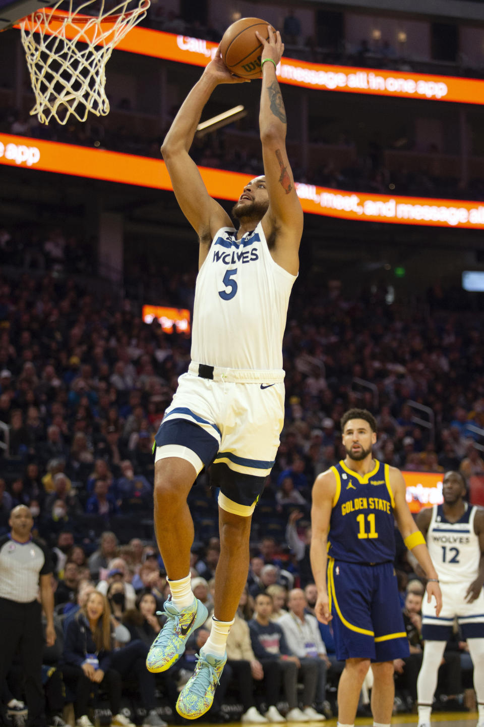 Minnesota Timberwolves forward Kyle Anderson (5) dunks ahead of Golden State Warriors guard Klay Thompson (11) during the first quarter of an NBA basketball game, Sunday, March 26, 2023, in San Francisco. (AP Photo/D. Ross Cameron)