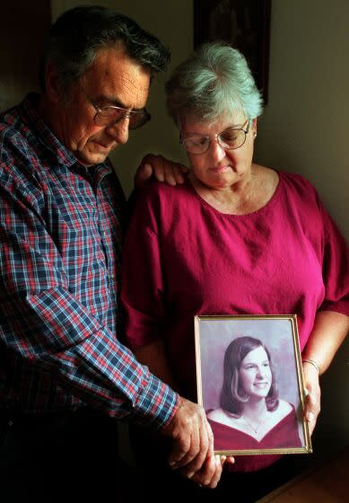 Al and Elaine Cavaletto hold one of their favorite pictures of their daughter Monica Leech.