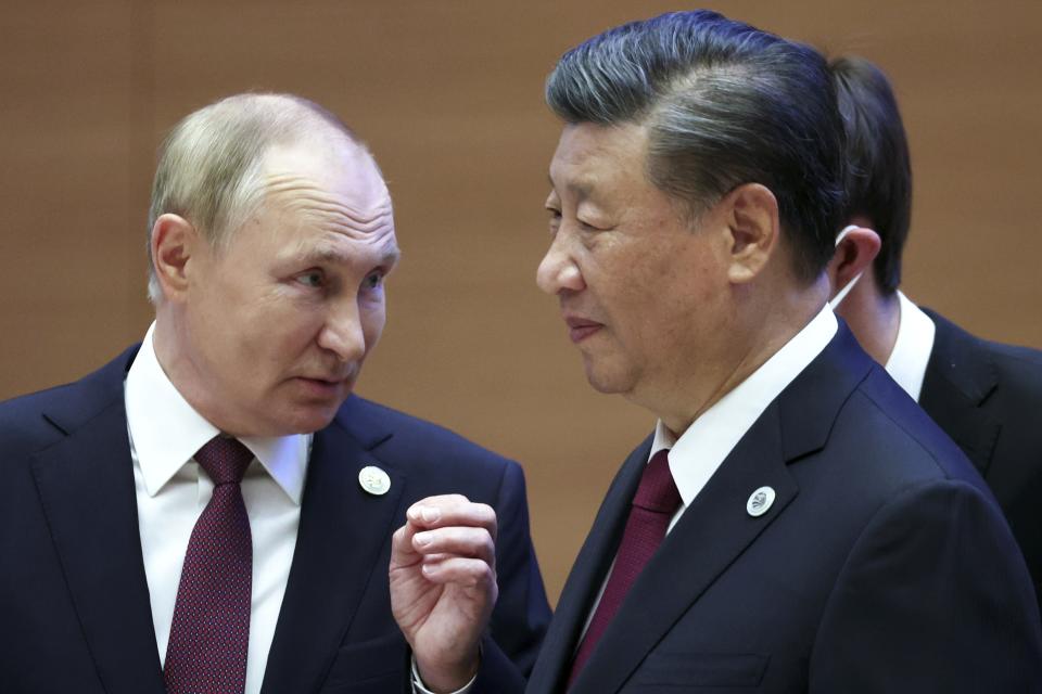FILE - Russian President Vladimir Putin, left, gestures while speaking to Chinese President Xi Jinping during the Shanghai Cooperation Organization summit in Samarkand, Uzbekistan, on Sept. 16, 2022. Putin is traveling to China on Thursday on his first foreign trip as he starts his fifth term, a visit that underlines an increasingly close partnership between Moscow and Beijing. (Sergei Bobylev, Sputnik, Kremlin Pool Photo via AP, File)