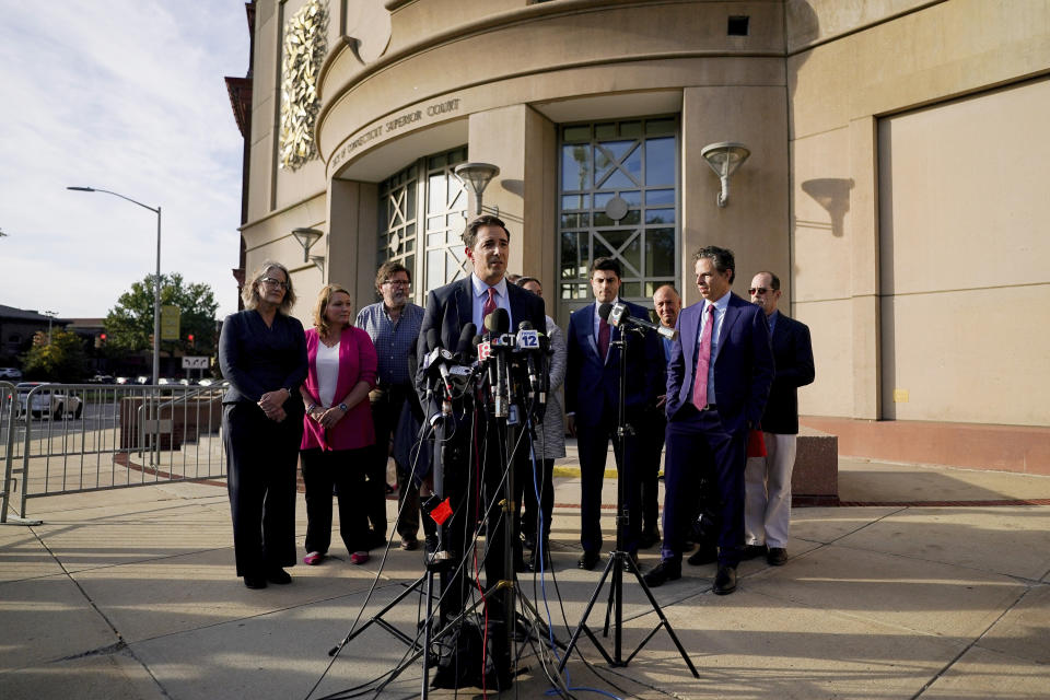 Attorney Chris Mattie speaks to the media after jurors returned a $965 million dollar judgement in defamation trial against Alex Jones, in Waterbury, Conn, Wednesday, Oct. 12, 2022. (AP Photo/Bryan Woolston)