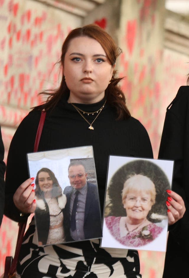 Hannah Brady, holding up photos of her family members Shaun Brady and Margaret Brady, who she lost to coronavirus (James Manning/PA)