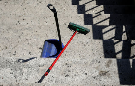 A broom and a dust pan belonging to Christian Okoro of Nigeria are seen in a street in downtown Rome, Italy, May 18, 2017. Picture taken May 18, 2017. REUTERS/Max Rossi