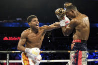 Shakur Stevenson, left, lands a punch on Jamel Herring during a junior lightweight boxing bout in Atlanta early Sunday, Oct. 24, 2021. Stevenson won the bout. (AP Photo/Ben Gray)