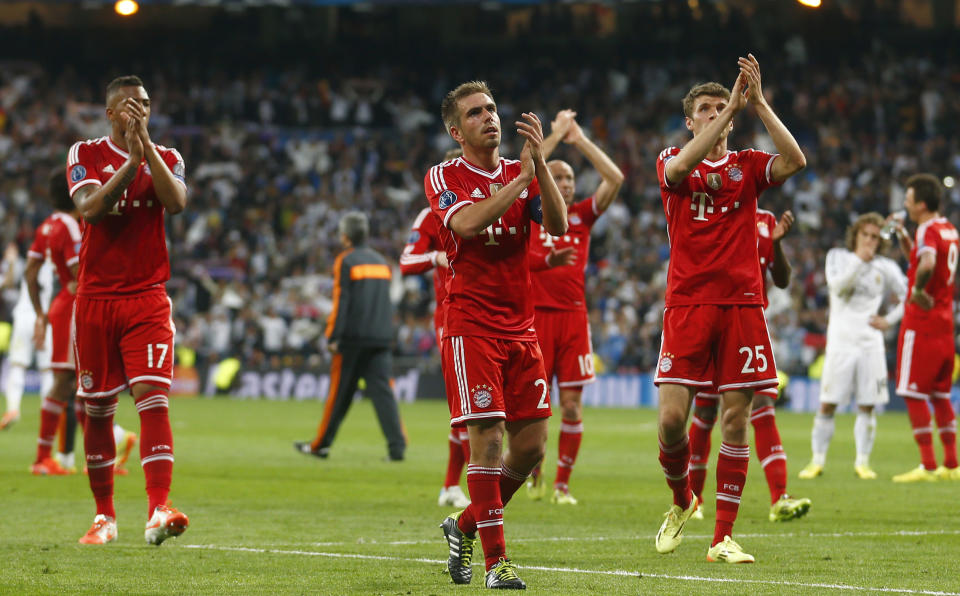 Bayern's Jerome Boateng, Philipp Lahm and Thomas Mueller, from left, acknowledge the fans after losing 0-1 in a Champions League semifinal first leg soccer match between Real Madrid and Bayern Munich at the Santiago Bernabeu stadium in Madrid, Spain, Wednesday, April 23, 2014 .(AP Photo/Paul White)