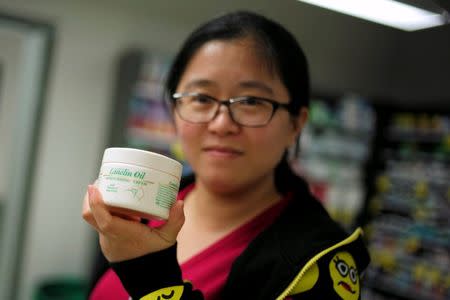 Chinese "daigou" shopping agent Na Wang shows an Australian moisturizer popular in China, during a shopping trip to procure goods for Chinese customers, at an Australian supermarket in Sydney, Australia August 2, 2016. Picture taken August 2, 2016. REUTERS/Jason Reed