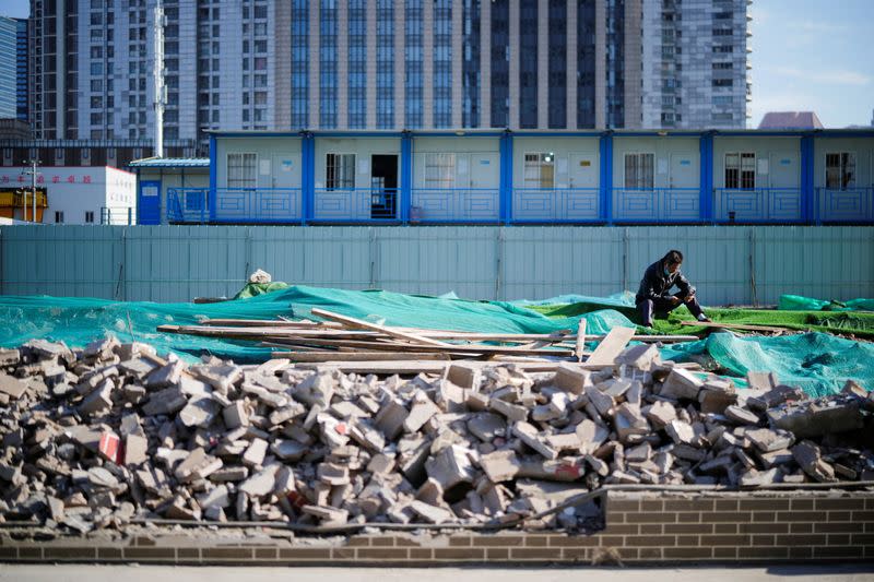 A worker rests on an unfinished road, following the coronavirus disease (COVID-19) outbreak, in Shanghai