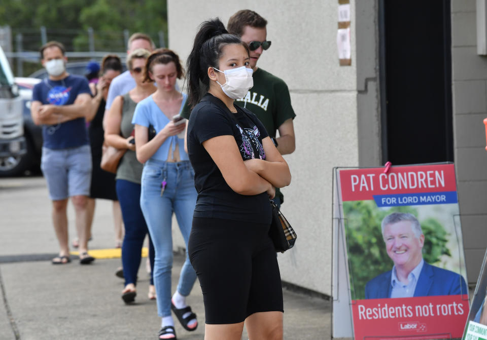 Voters are seen lined up at the Coorparoo pre-polling booth for the Brisbane City Council elections on Wednesday. Source: AAP