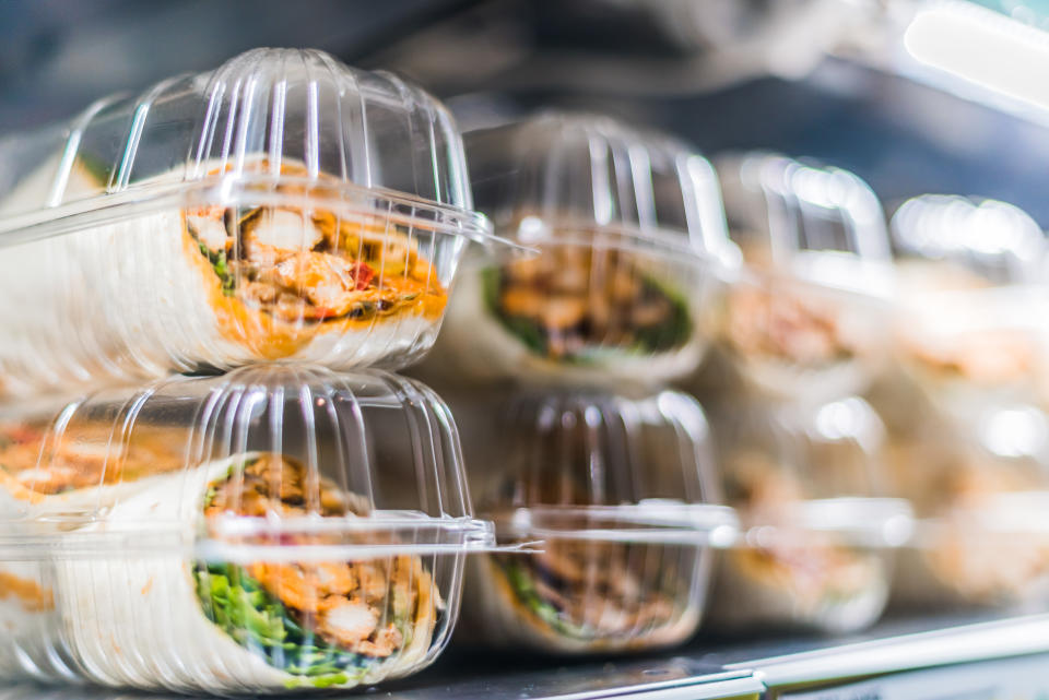 Pre-packaged sandwiches displayed in a commercial refrigerator