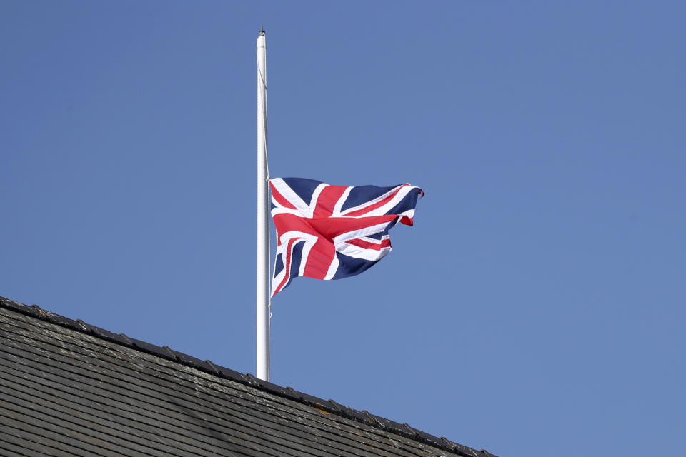 The Union Jack flies at half mast behind the stands in honour of the late Prince Philip, Duke of Edinburgh, during races on the second day of the Grand National Horse Racing meeting at Aintree racecourse, near Liverpool, England, Friday April 9, 2021. (AP Photo/Scott Heppell, Pool)