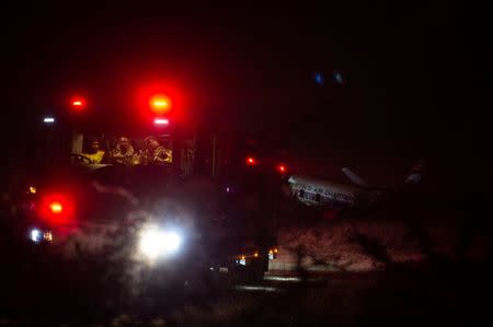 Firemen sit in a truck at the scene of a plane crash outside the South Africa's capital Pretoria, South Africa, July 10,2018. REUTERS/Yeshiel Panchia