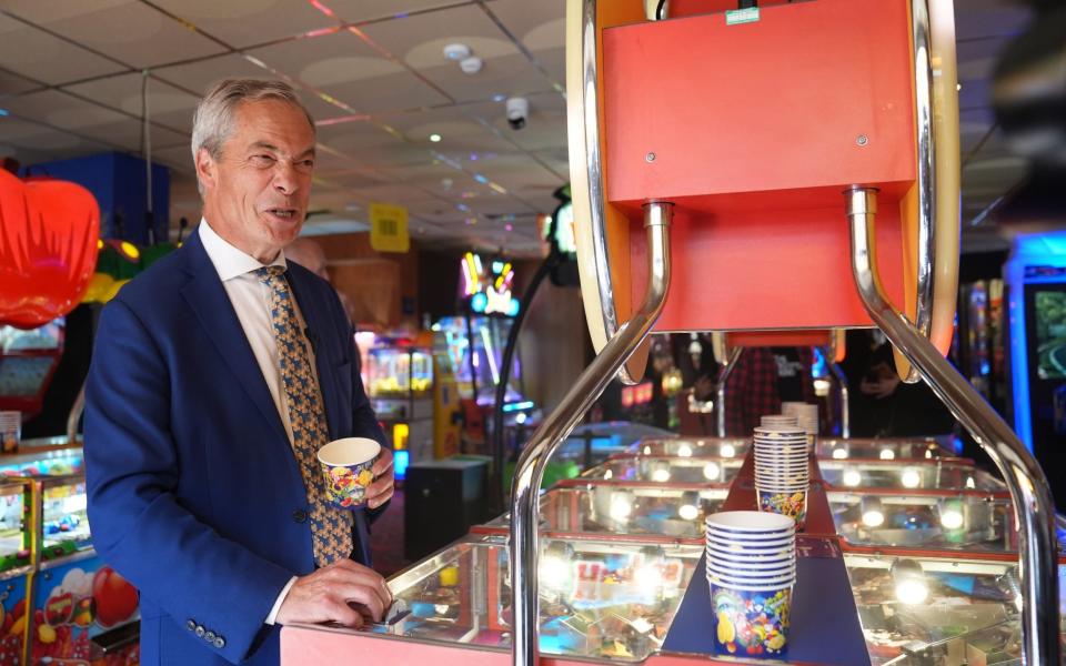 Nigel Farage playing a 2p machine in Clacton-on-Sea, Essex