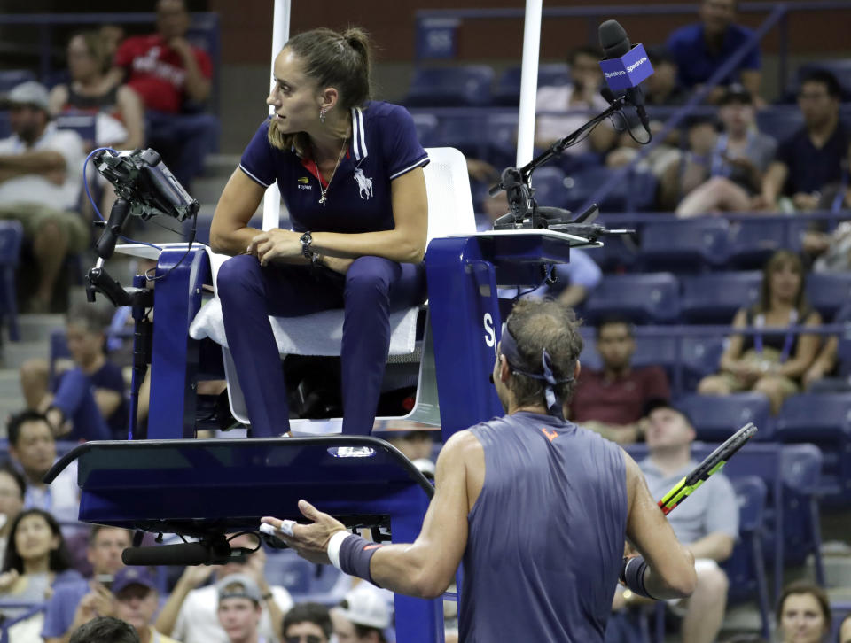 Rafael Nadal, of Spain, talks to the chair umpire during his second-round match against Vasek Pospisil, of Canada, at the U.S. Open tennis tournament, Wednesday, Aug. 29, 2018, in New York. Nadal received a warning for letting the serve clock expire. (AP Photo/Julio Cortez)