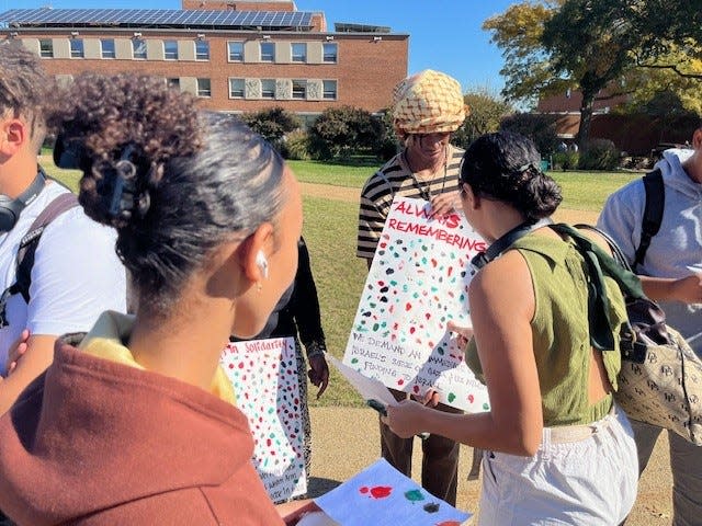 Aaron McIntrye held up a poster Oct. 25, 2023 for students at Howard University in Washington, D.C., to mark with their thumb prints in support of Palestinians.