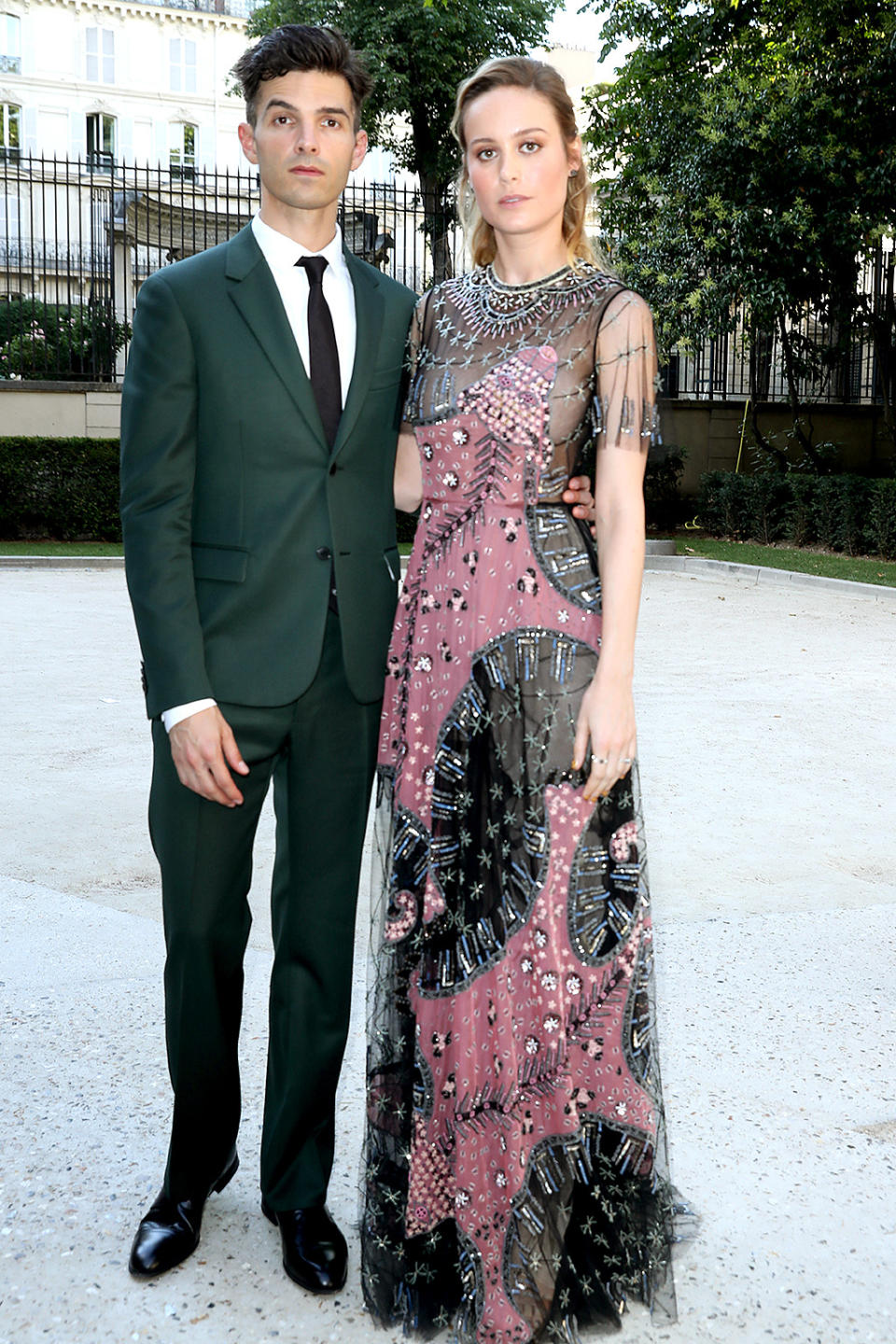 <p>Larson and fiancé Alex Greenwald gave their best serious faces, before sitting with the VIPs to see the haute couture looks that Valentino has planned for the world this fall. (Photo: Antonio de Moraes Barros Filho/WireImage) </p>