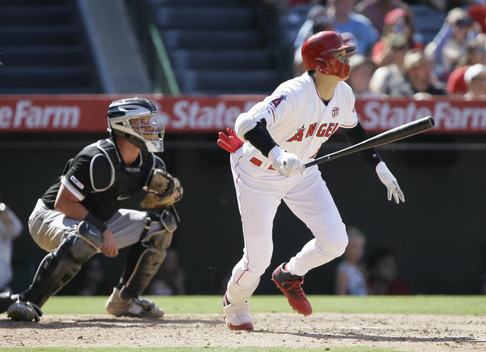 Los Angeles Angels designated hitter Shohei Ohtani, right, watches his two-run home run with Chicago White Sox catcher James McCann, left, during the seventh inning of a baseball game in Anaheim, Calif., Sunday, Aug. 18, 2019. (AP Photo/Alex Gallardo)