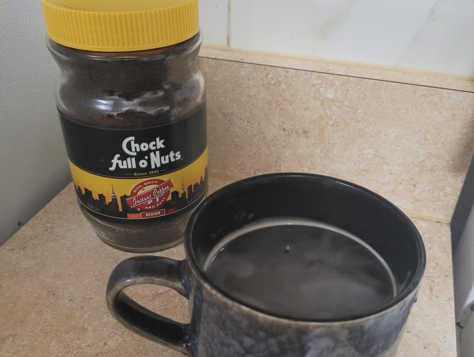 chock full o nuts instant coffee next to a prepared cup of instant coffee